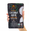 Hand holding a package of Siam Premium Coconut Milk on a white background