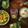 Siam Green Thai Curry Paste packaging with curry dish, rice, and ingredients on a wooden table